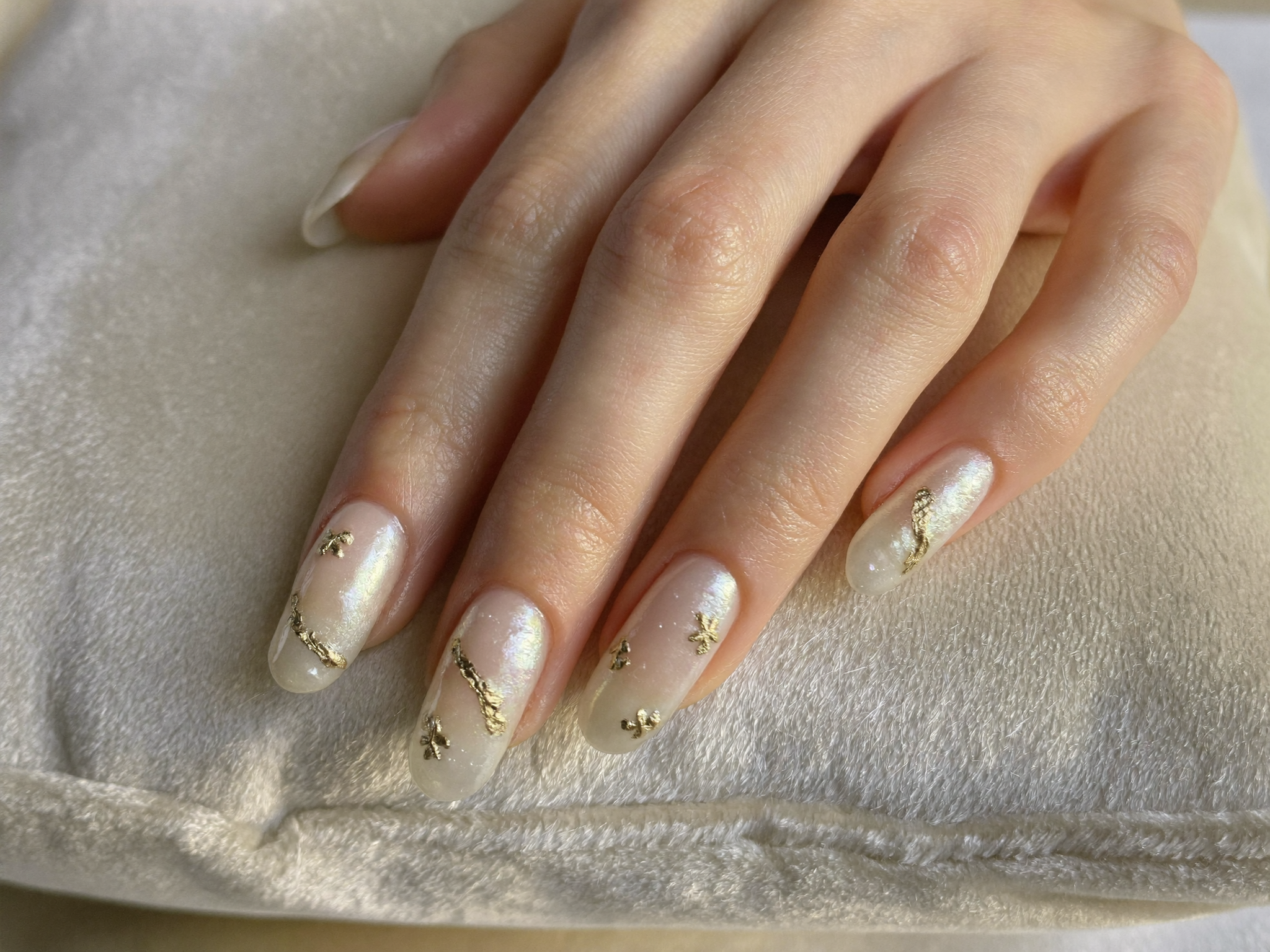 Close-up of an immaculate pearl-shimmer gel manicure