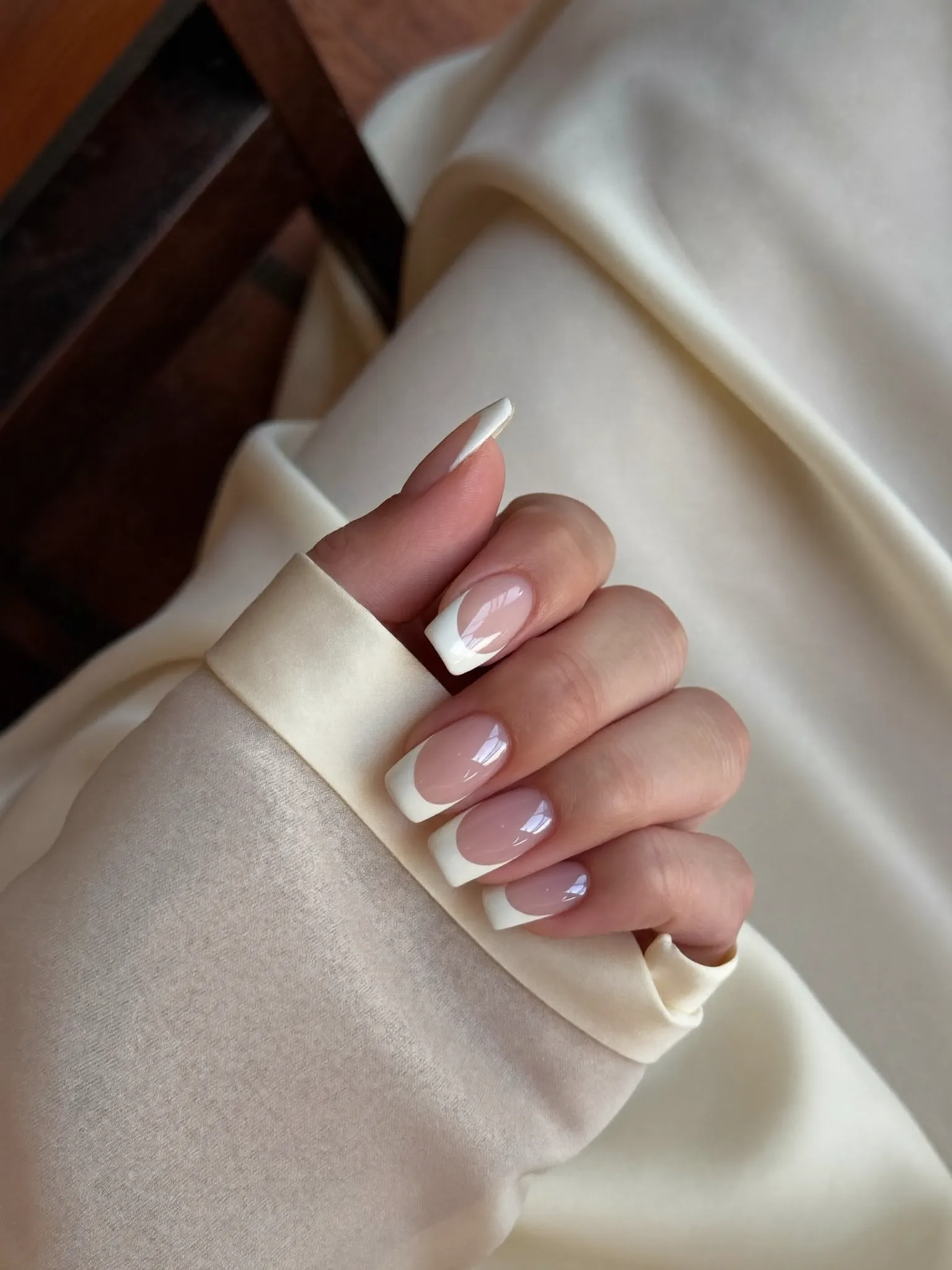 Classic French tip manicure on silk fabric