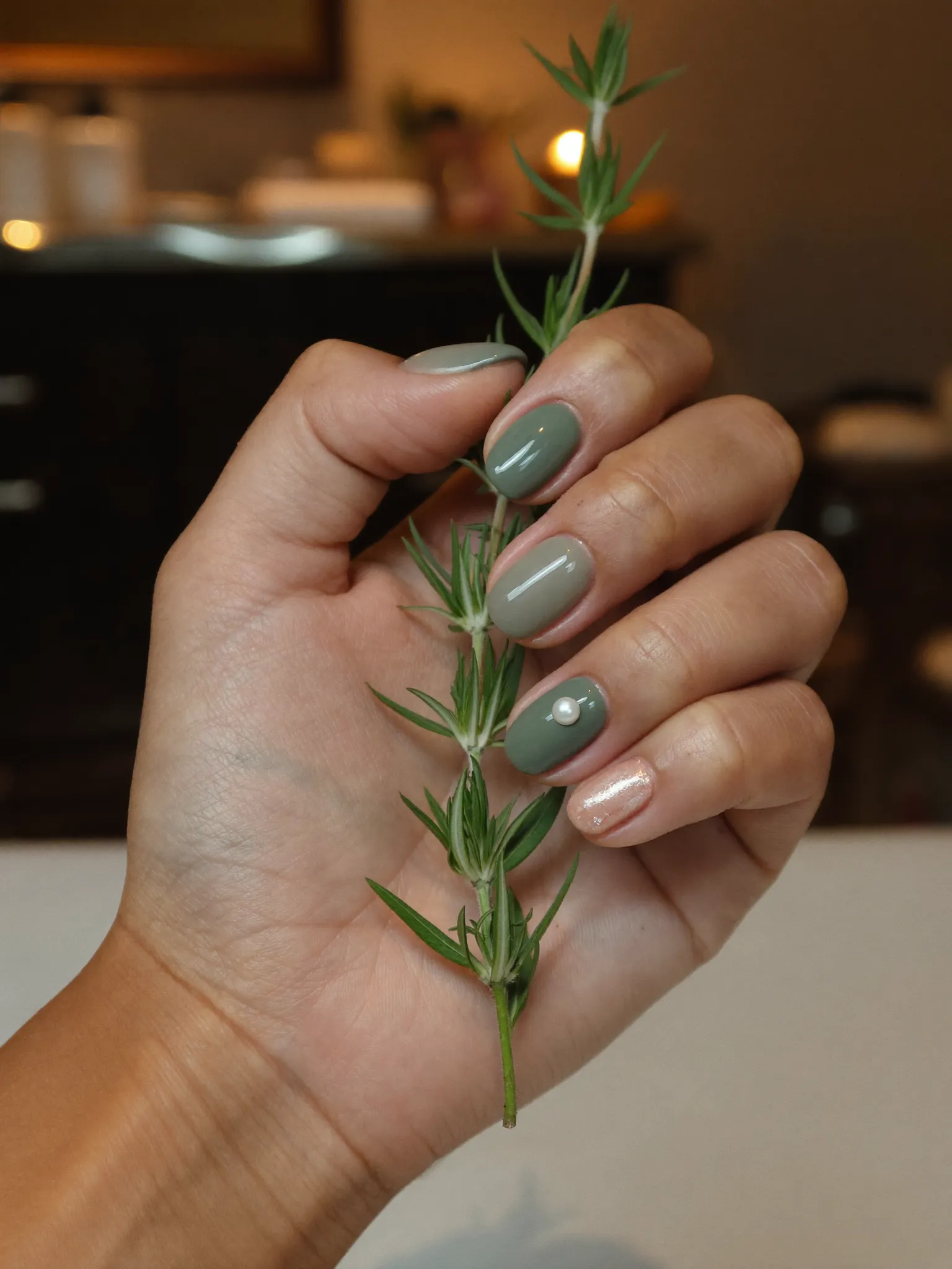 Seasonal nail colors in sage and terracotta with a pearl accent